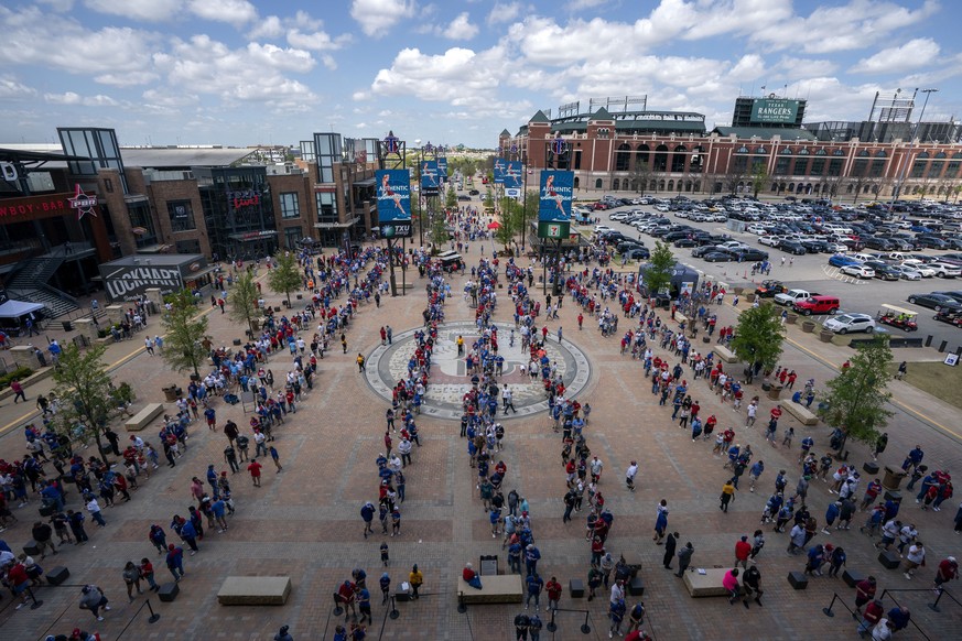 Fans line up to enter Globe Life Field before the Texas Rangers home opener baseball game against the Toronto Blue Jays on Monday, April 5, 2021, in Arlington, Texas. The Texas Rangers are set to have ...