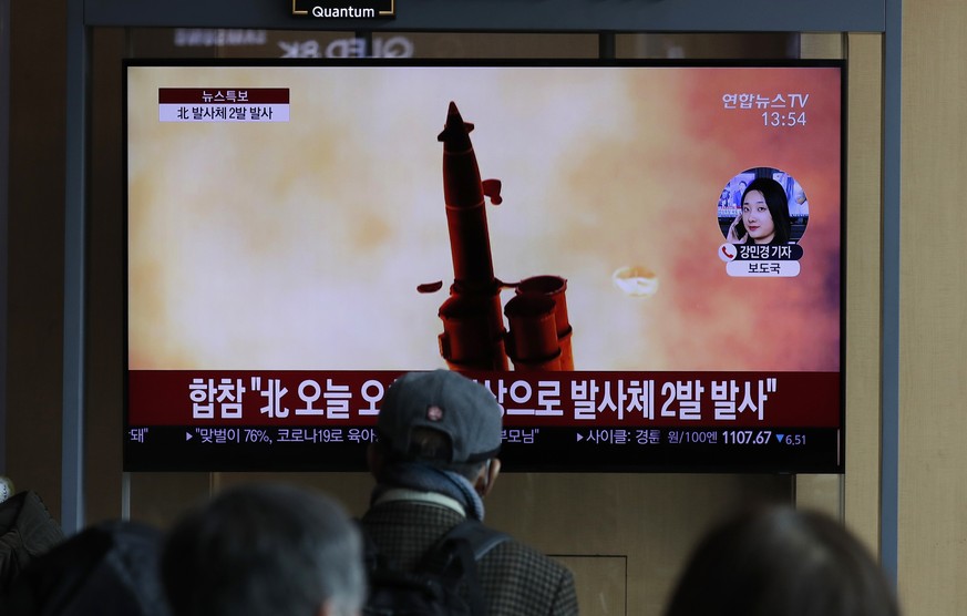 People watch a TV screen showing a news program reporting about North Korea&#039;s firing of projectiles with a file image at the Seoul Railway Station in Seoul, South Korea, Monday, March 2, 2020. No ...
