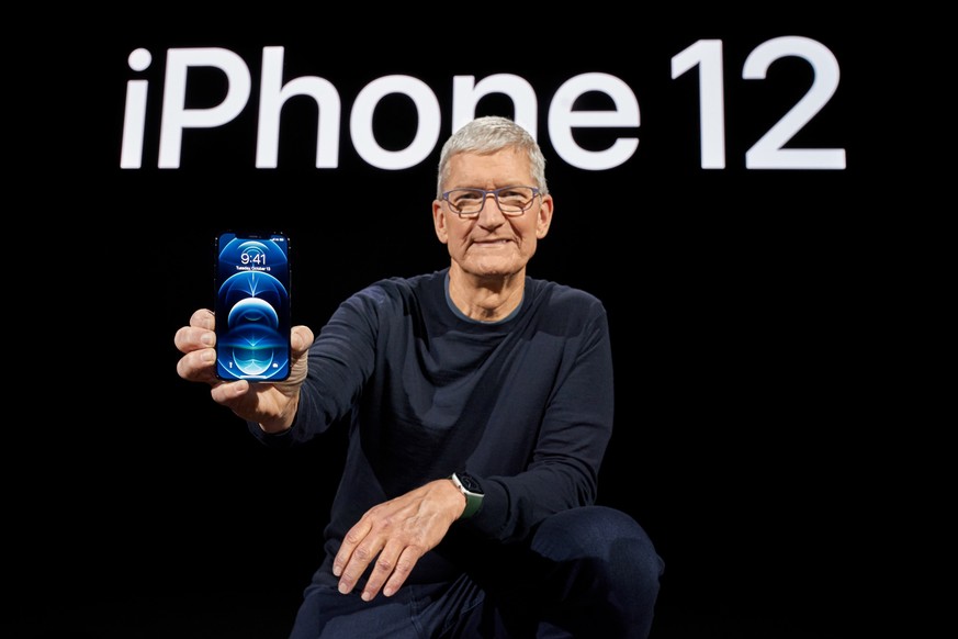 epa08741384 Handout image released by Apple showing Apple CEO Tim Cook showcasing the all-new iPhone 12 Pro during a special event at Apple Park in Cupertino, California, USA, 13 October 2020. Apple i ...