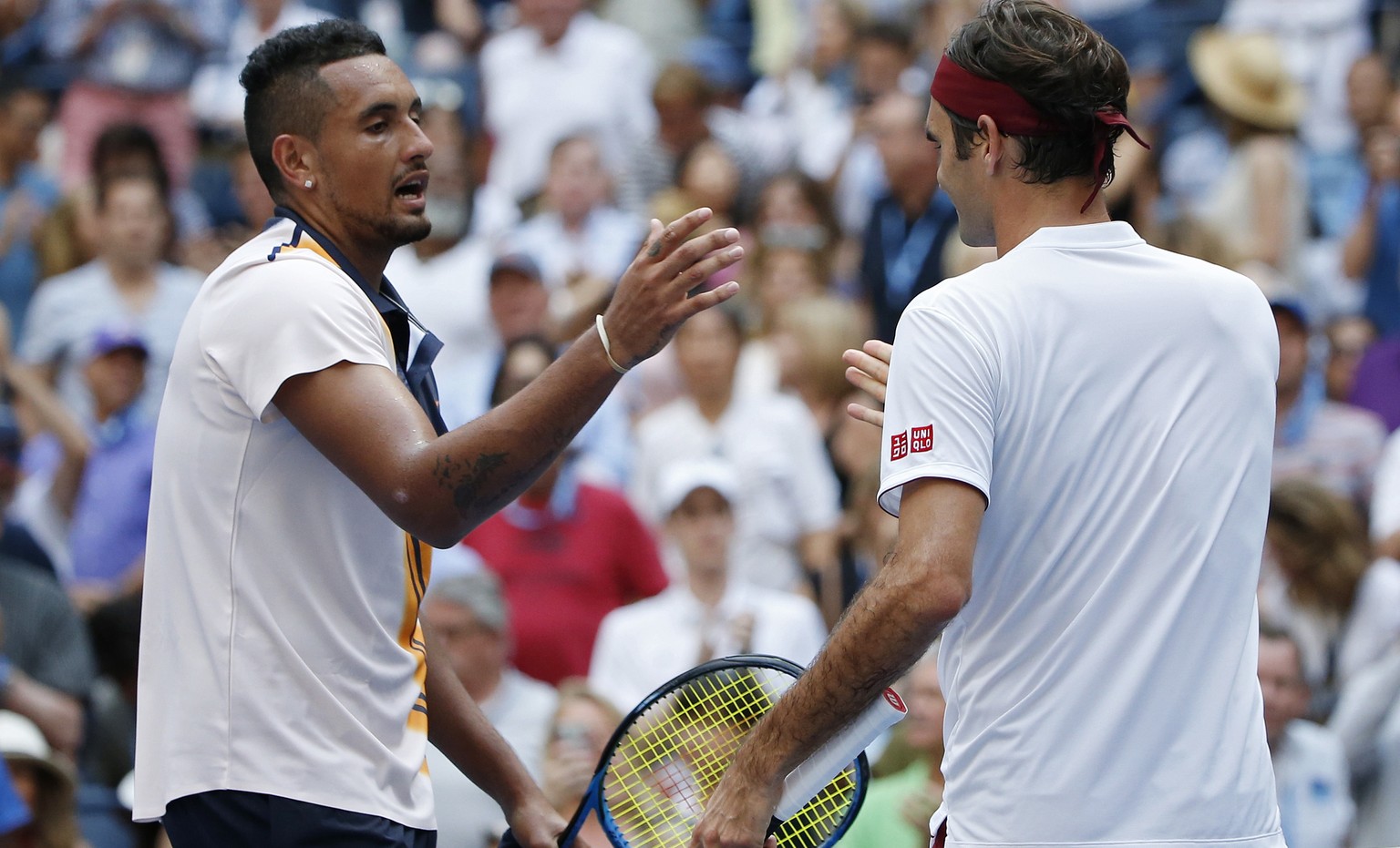 Roger Federer, right, of Switzerland, shakes hands with Nick Kyrgios, of Australia, after Federer defeated Kyrgios during the third round of the U.S. Open tennis tournament, Saturday, Sept. 1, 2018, i ...