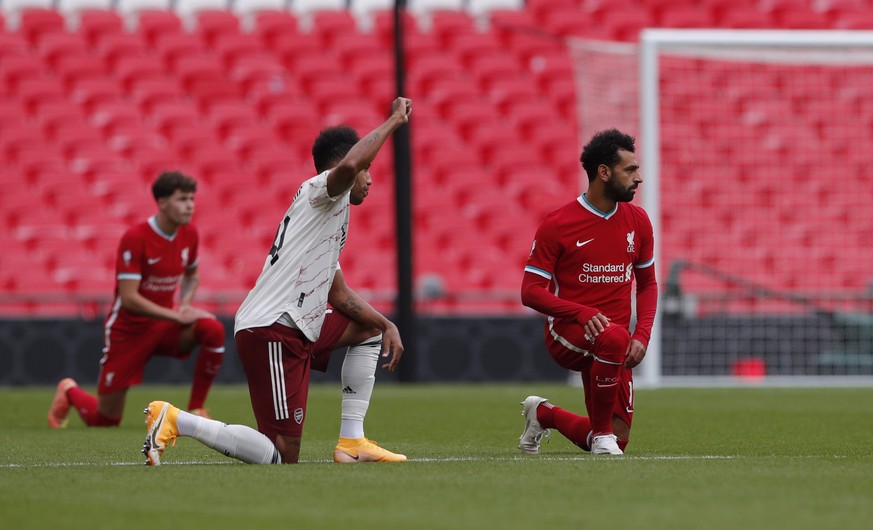 Players take a knee in support of the Black Lives Matter movement before the English FA Community Shield soccer match between Arsenal and Liverpool at Wembley stadium in London, Saturday, Aug. 29, 202 ...