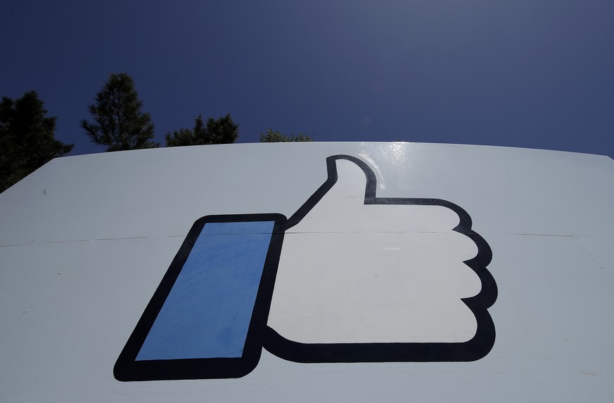 FILE - This April 25, 2019, file photo shows the thumbs-up &quot;Like&quot; logo on a sign at Facebook headquarters in Menlo Park, Calif. Facebook, following in Google