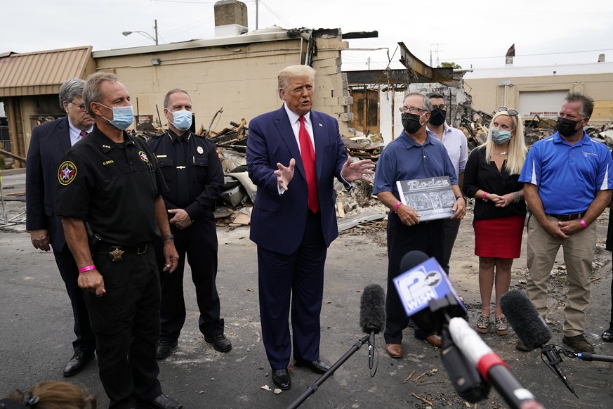 President Donald Trump talks with reporters Tuesday, Sept. 1, 2020, as he tours an area damaged during demonstrations after a police officer shot Jacob Blake in Kenosha, Wis. (AP Photo/Evan Vucci)
Don ...