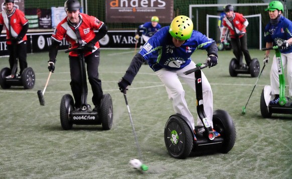 epa05172031 Members of two teams are in action during the Segway Polo Tournament in Bad Nenndorf, Germany, 20 February 2016. A total of ten teams, including two from England and one from Switzerland,  ...