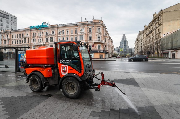 epa08400006 Municipal vehicles spray disinfectant on the deserted streets in downtown of Moscow, Russia, 04 May 2020. Russian President Vladimir Putin extended a home quarantine to 11 May 2020 to prev ...