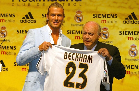 David Beckham (left) holds his new number 23 Real Madrid shirt presented to him by honorary president and former player Alfredo Di Stefano as he is formally unveiled at the basketball stadium next to  ...