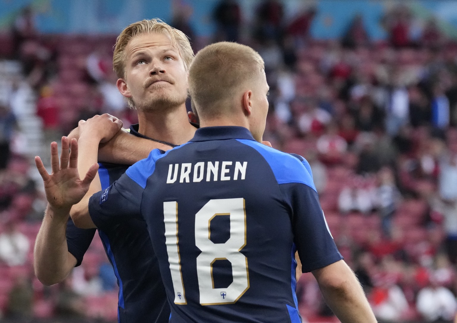 Finland&#039;s Joel Pohjanpalo, left, celebrates after scoring his side&#039;s opening goal during the Euro 2020 soccer championship group B match between Denmark and Finland at Parken stadium in Cope ...
