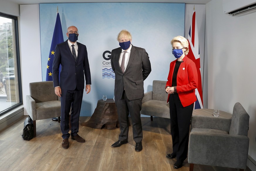 Britain&#039;s Prime Minister Boris Johnson, center, meets with European Commission President Ursula von der Leyen and European Council President Charles Michel, left, during the G7 summit in Cornwall ...