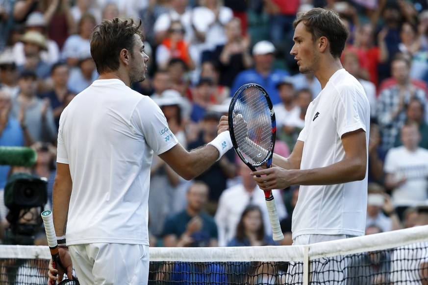 Stan Wawrinka of Switzerland, left, and Daniil Medvedev of Russia shake hands after their Men&#039;s Singles Match on the opening day at the Wimbledon Tennis Championships in London Monday, July 3, 20 ...