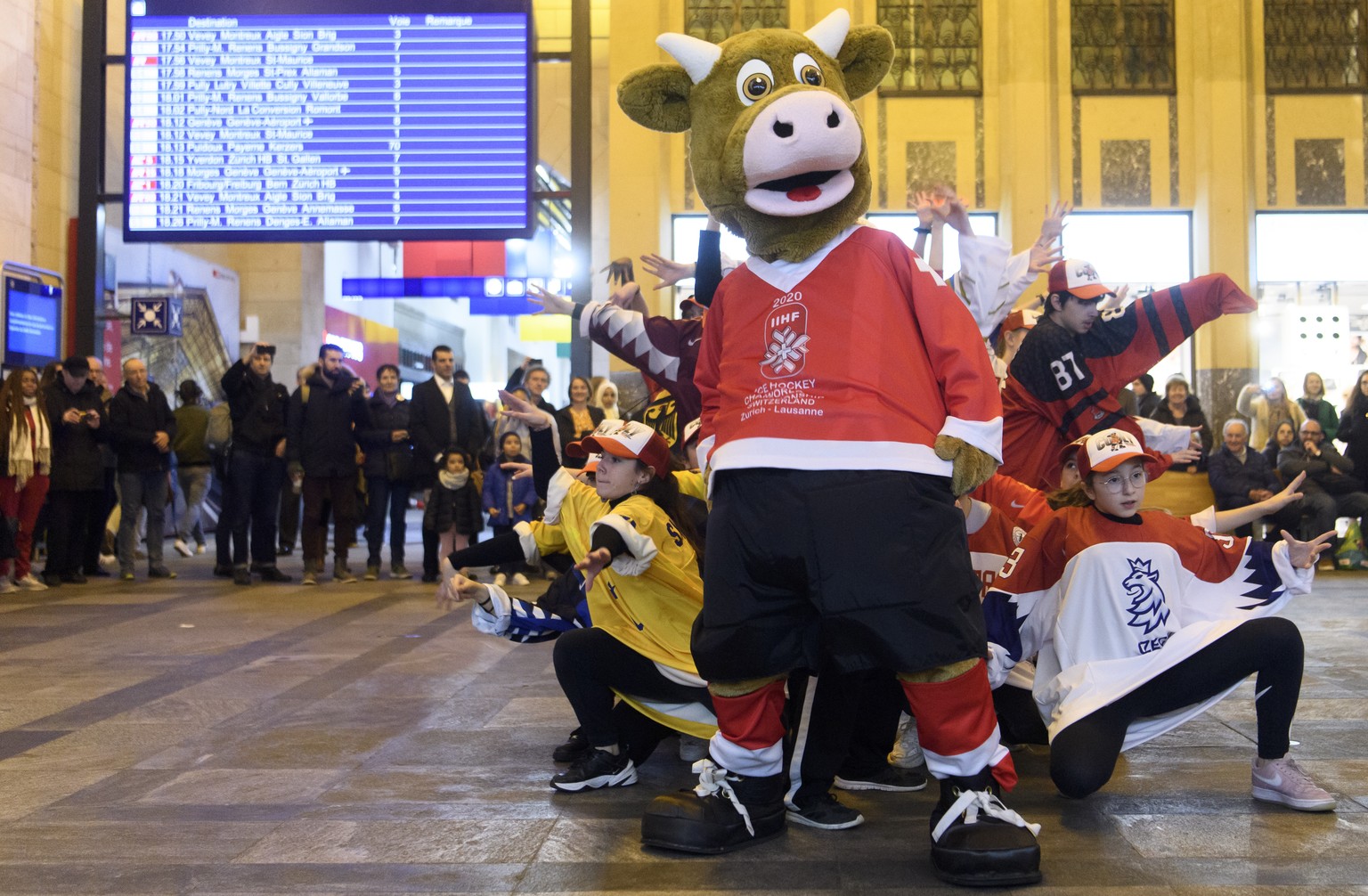 Cooly, the official mascot of the 2020 IIHF Ice Hockey World Championship dance with kids during a flashmob 100 days before the 2020 IIHF Ice Hockey World Championship at the CFF train station, in Lau ...
