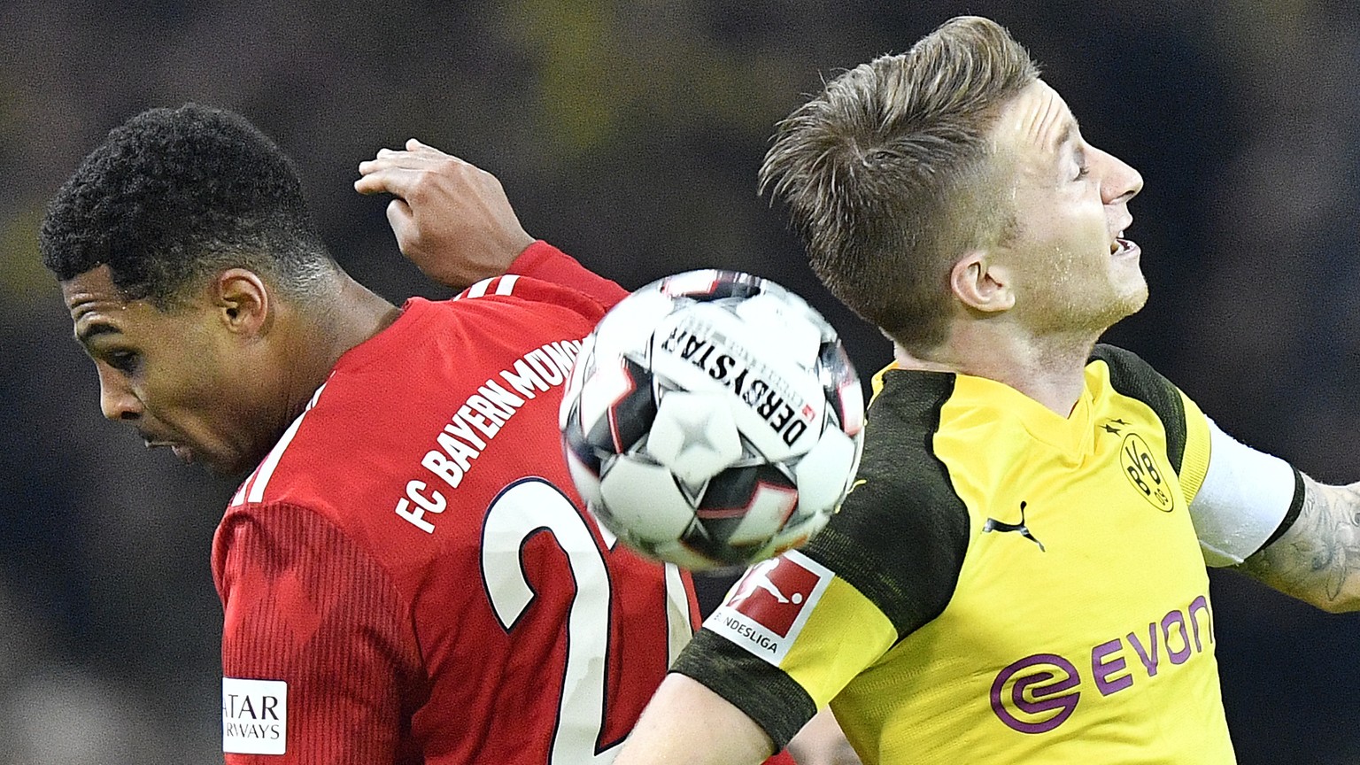 In this Saturday, Nov. 10, 2018, file photo, Bayern&#039;s Serge Gnabry, left, and Dortmund&#039;s Marco Reus challenge for the ball during the German Bundesliga soccer match between Borussia Dortmund ...