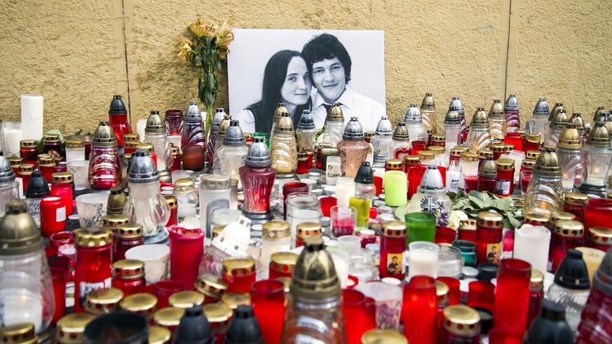 Candles are left in tribute to murdered Slovakian investigative reporter Jan Kuciak, 27, and his fiancee Martina, 27, at Slovak National Uprising Square in Bratislava, on Tuesday, Feb. 27, 2018. A lea ...