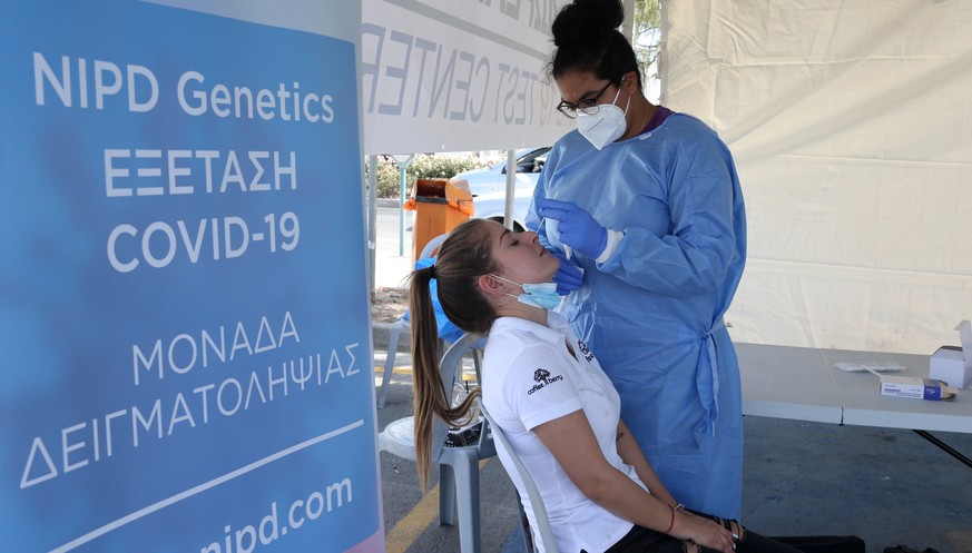 epa08696373 Health workers carry out coronavirus tests on people in the southern coastal city of Larnaca, Cyprus, 25 September 2020. Health authorities in Cyprus are ramping up coronavirus testing in  ...