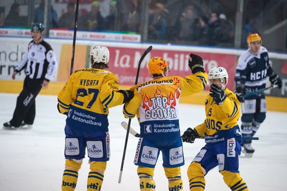 Davos&#039;s player Magnus Nygren, Davos&#039;s player Broc Little and Davos&#039;s player Mikael Johansson, from left, celebrate the 0-2 goal, during the preliminary round game of National League Swi ...