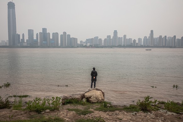 epa08340731 A man stands on the banks of the Yangtze River, in Wuhan, China, 03 April 2020. China will hold a national mourning for coronavirus Covid-19 victims on 04 April. According to Chinese gover ...