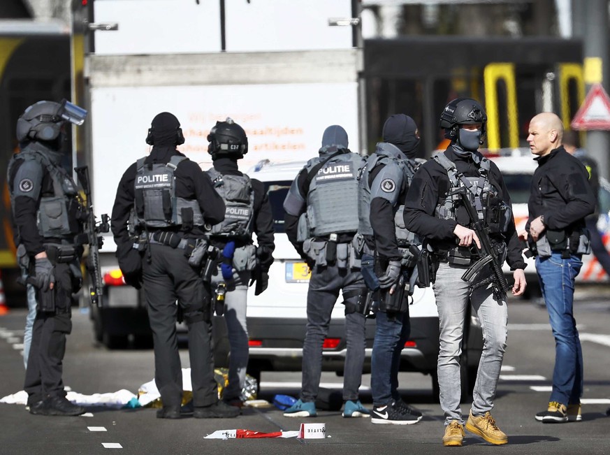 epa07446500 Armed police at the scene where a shooting took place at the 24 Oktoberplace in Utrecht, The Netherlands, 18 March 2019. According to the the Dutch Police, several people have been injured ...