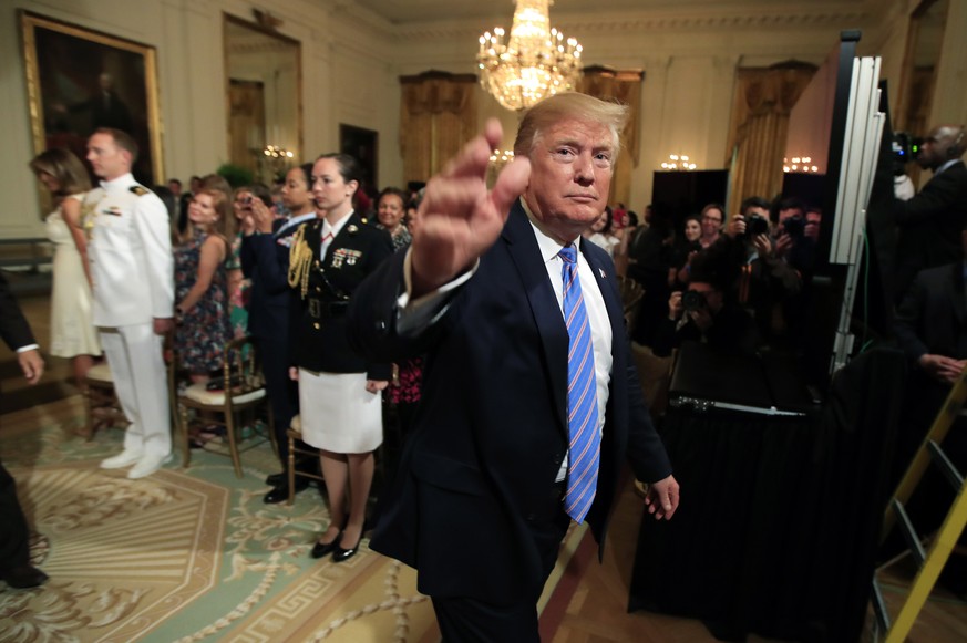 President Donald Trump waves as he leaves the East Room during a celebration of military mothers with first lady Melania Trump at the White House in Washington, Friday, May 10, 2019. (AP Photo/Manuel  ...
