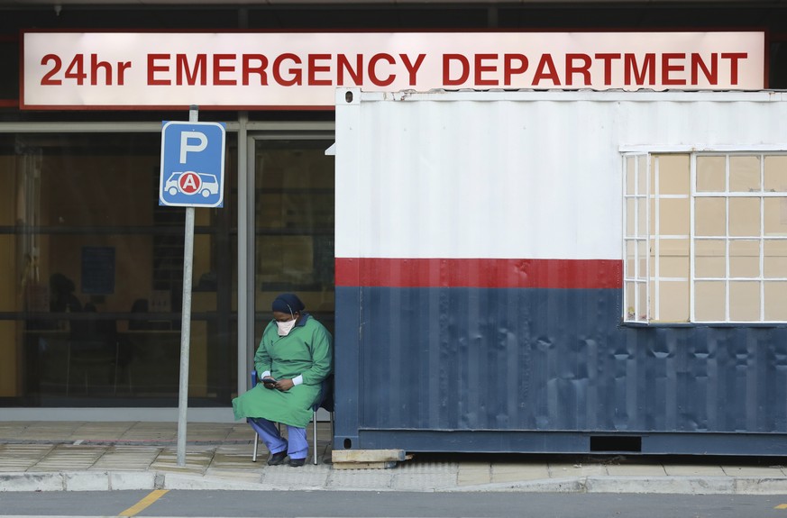 FILE �?? In this Wednesday June 17, 2020, file photo a health worker in personal protective gear takes a break at the Netcare Christiaan Barnard Memorial Hospital in Cape Town, South Africa. South Afr ...