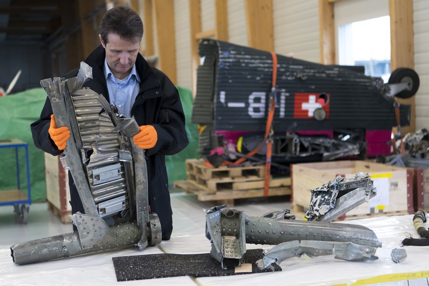 Michael Flueckiger chief investigator of the aviation sector of Swiss Transportation Safety Investigation Board, STSB, observes parts of the wreckage of the Junkers JU 52, HB-HOT, aircraft at the STSB ...