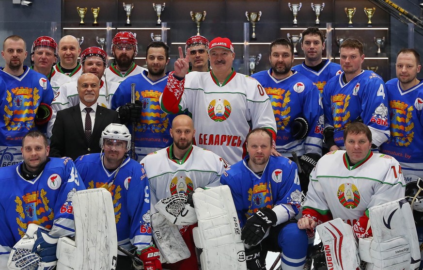 epa08343199 Belarusian President Alexander Lukashenko (C) poses with other players after the first ice hockey match of the final series of the XIII Republican amateur competition for the prizes of the ...