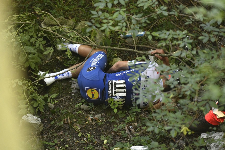 Cyclist Remco Evenepoel lies on the ground after he fell during the Tour of Lombardy cycling race, from Bergamo to Como, Italy, Saturday, Aug. 15, 2020. (Fabio Ferrari/LaPresse via AP)