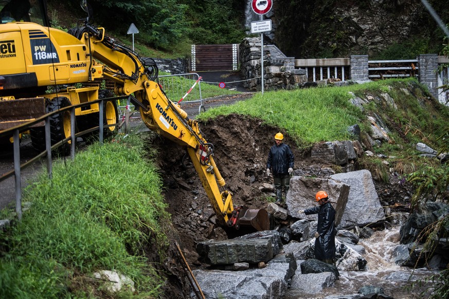 epa08635138 Clearance works in a riverbed after damages caused by bad weather in Gordola, Switzerland, 30 August 2020. The heavy rain has been causing water levels in the rivers and lakes of the Ticin ...
