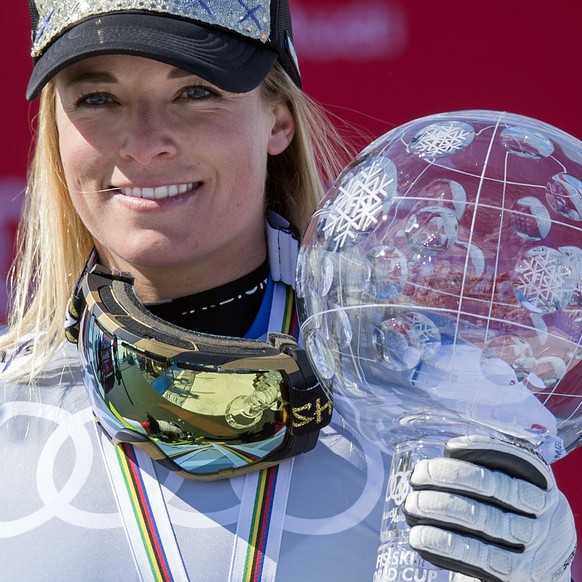 Lara Gut from Switzerland celebrates with the crystal globe as overall winner of this year&#039;s women World Cup in alpine skiing on the podium, at the FIS Alpine Ski World Cup Finals, in St. Moritz, ...