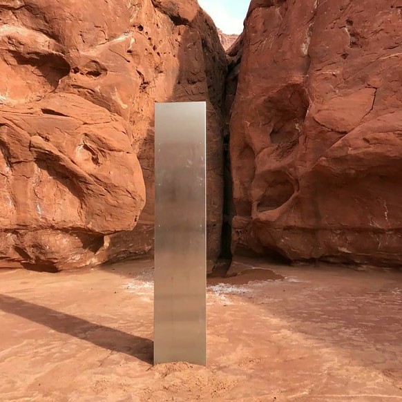 This Nov. 18, 2020 photo provided by the Utah Department of Public Safety shows a metal monolith installed in the ground in a remote area of red rock in Utah. The smooth, tall structure was found duri ...
