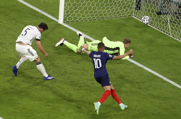 France&#039;s Kylian Mbappe, right, celebrates after Germany&#039;s Mats Hummels, left, scored an own goal during the Euro 2020 soccer championship group F match between France and Germany at the Alli ...