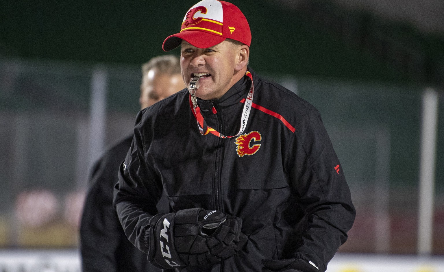 FILE - In this Oct. 25, 2019, file photo, Calgary Flames coach Bill Peters watches practice in Regina, Saskatchewan, ahead of the NHL Heritage Classic outdoor hockey game against the Winnipeg Jets. Ca ...