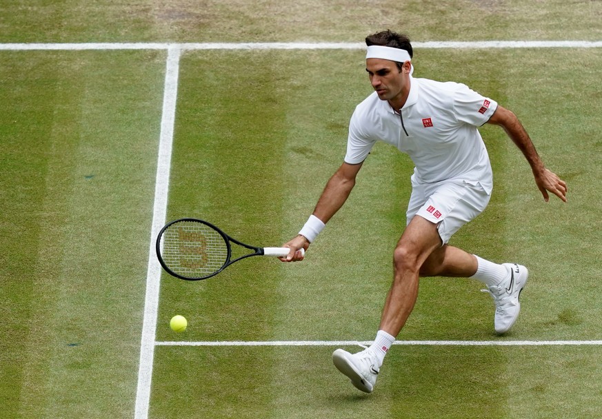 epa07716678 Roger Federer of Switzerland in action against Novak Djokovic of Serbia during their Men&#039;s final match for the Wimbledon Championships at the All England Lawn Tennis Club, in London,  ...