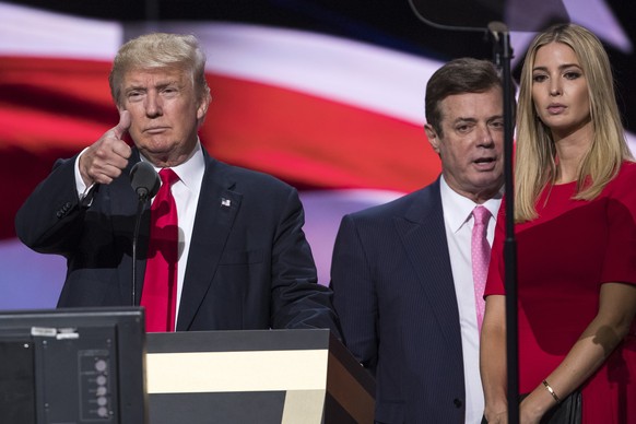 FILE - In this July 21, 2016 file photo, then-Trump Campaign manager Paul Manafort stands between the then-Republican presidential candidate Donald Trump and his daughter Ivanka Trump during a walk th ...