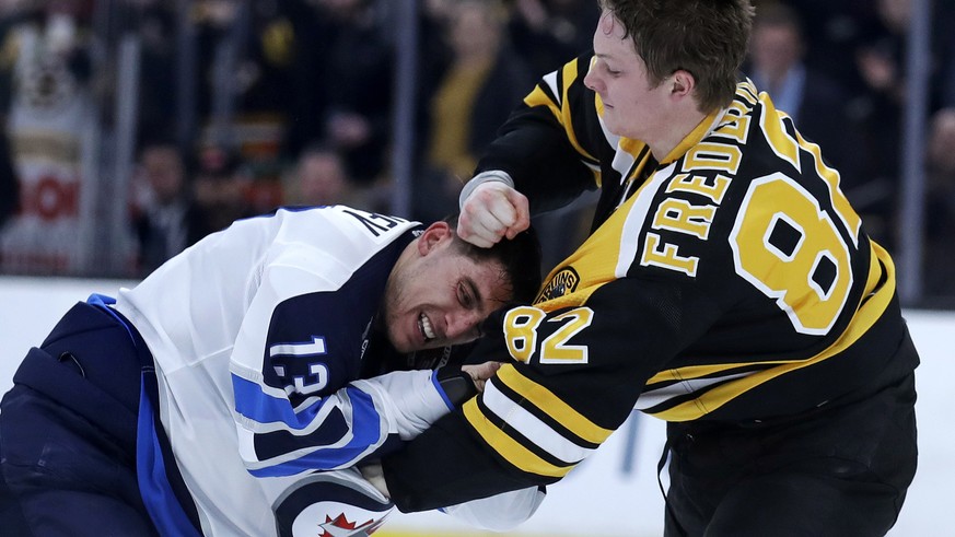 Boston Bruins center Trent Frederic (82) fights Winnipeg Jets left wing Brandon Tanev (13) during the second period of an NHL hockey game in Boston, Tuesday, Jan. 29, 2019. (AP Photo/Charles Krupa)