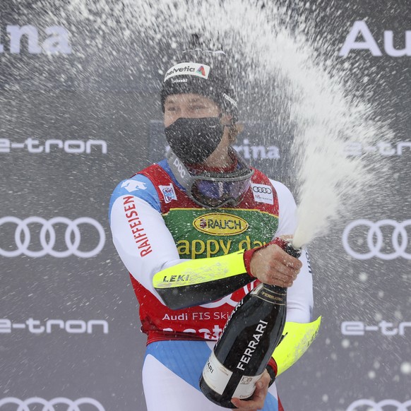 Switzerland&#039;s Marco Odermatt celebrates on the podium after winning the alpine ski World Cup men&#039;s giant slalom in Santa Caterina Valfurva, Italy, Monday, Dec. 7, 2020. (AP Photo/Alessandro  ...