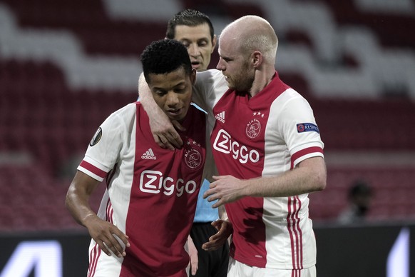 Ajax&#039;s David Neres, right, celebrates hid goal with his teammate Davy Klaassen, scored a first goal, during the Europa League round of 32 second leg soccer match between Ajax and Lille at the Joh ...