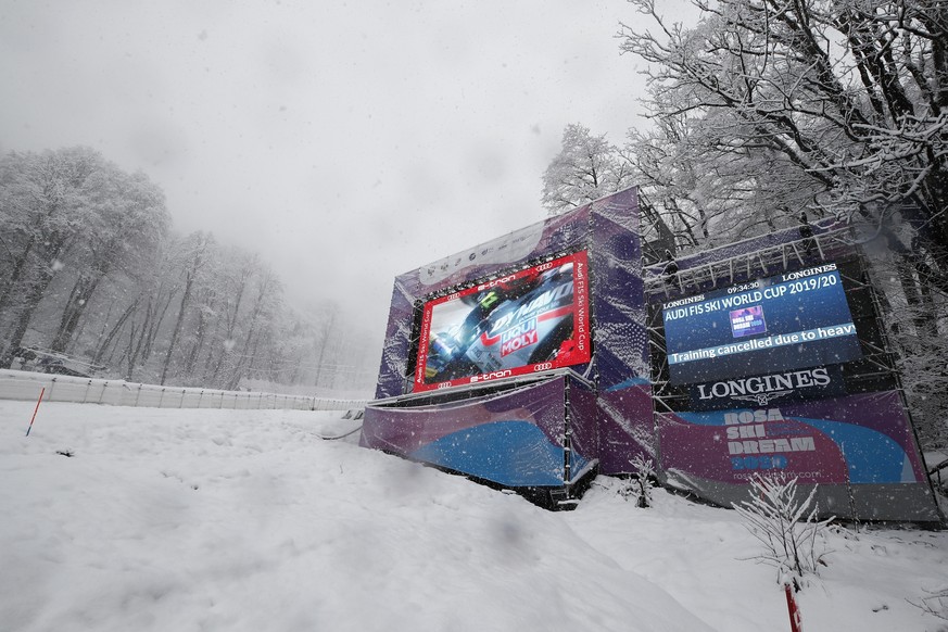 Writing on a giant screen announced that an alpine ski, women&#039;s World Cup downhill training is canceled due to heavy snow, in Rosa Khutor, Russia, Friday, Jan. 31, 2020. (AP Photo/Gabriele Faccio ...
