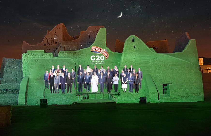 epa08831516 A handout photo made available by G20 Riyadh Summit shows a virtual family photo of G20 leaders projected on the walls of At-Turaif District in Ad-Diriyah, Riyadh, Saudi Arabia (issued 20  ...