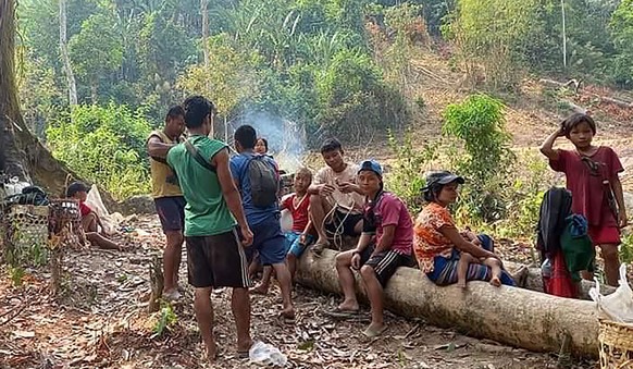 In this photo released by the Free Burma Rangers, Karen villagers gather in the forests as they hide from military airstrikes in the Deh Bu Noh area of the Papun district, north Karen state, Myanmar,  ...