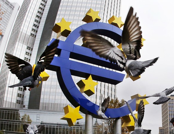 FILE - In this Thursday, Nov. 10, 2016 filer, Pigeons fly in front of the Euro sculpture at the old European Central Bank bulding in Frankfurt, Germany. Italy&#039;s political turmoil has roiled globa ...
