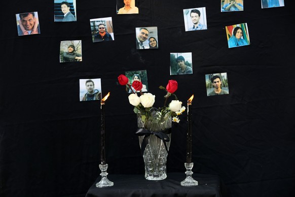 epaselect epa08127245 Iranian students light candles during a memorial ceremony for passengers of Ukraine airplane, at the Tehran university in Tehran, Iran, 14 January 2020. Media reported that some  ...