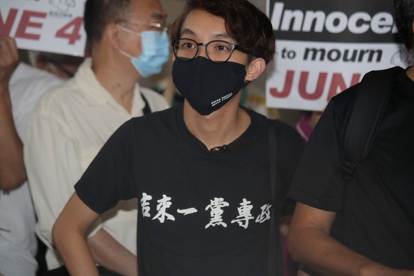 Pro-democracy activist Figo Chan Ho-wun wears a T-shirt with Chinese words reading &quot;&quot;Put an end to one-party Dictatorship&quot; outside a court in Hong Kong, Tuesday, Sept. 15, 2020. Promine ...