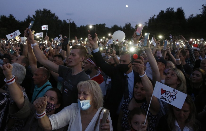 epa08575317 People attend a campaign rally of Belarusian opposition presidential candidate Svetlana Tikhanovskaya in Minsk, Belarus, 30 July 2020. The presidential election in Belarus is scheduled to  ...