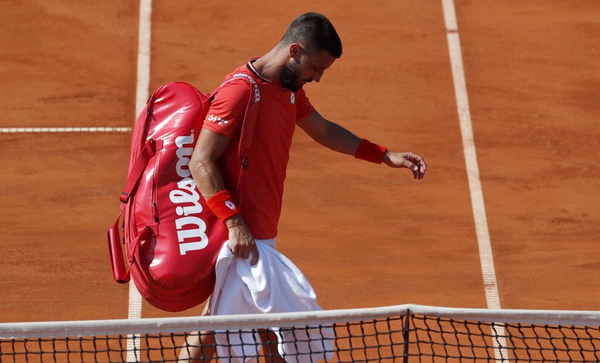 Damir Dzumhur of Bosnia leaves the court after an injury during the match of the Adria Tour charity tournament with Austria&#039;s Dominic Thiem in Belgrade, Serbia, Saturday, June 13, 2020. Serbian t ...
