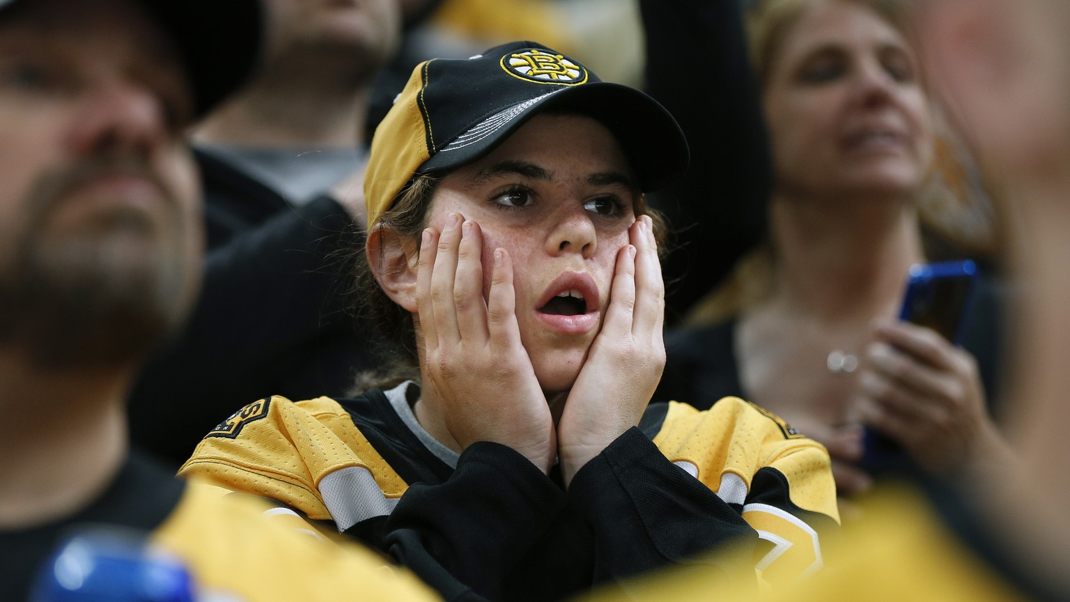 Boston Bruins fans watch the closing minutes of Game 5 of the NHL hockey Stanley Cup Final between the Bruins and the St. Louis Blues, Thursday, June 6, 2019, in Boston. (AP Photo/Michael Dwyer)