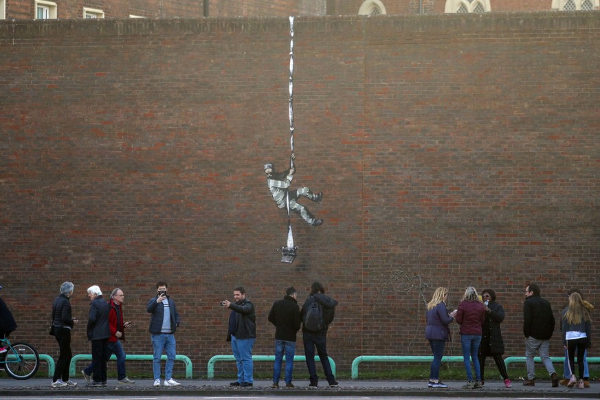 Banksy&#039;s latest artwork which appeared in Reading, England, March 1, 2021. Street artist Banksy has confirmed that he was behind the artwork that appeared on the red brick wall of a former prison ...