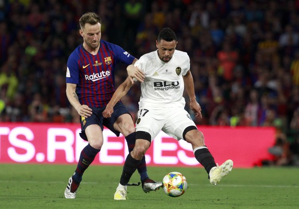 Valencia midfielder Francis Coquelin, right, battles for the ball with Barcelona midfielder Ivan Rakitic during the Copa del Rey soccer match final between Valencia CF and FC Barcelona at the Benito V ...