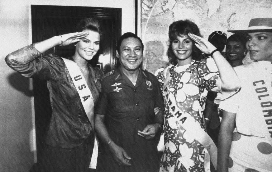 ADDS CONFIRMATION BY PANAMANIAN PRESIDENT, FILE - In this July 5, 1986 file photo, Miss USA, Christy Fichtner, left, and Miss Panama, Gilda Garcia Lopez, salute while flanking General Manuel Antonio N ...