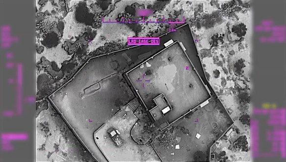epa07961152 A screengrab from a handout military drone video made available by the US Defense Video and Imagery Distribution System (DVIDS) shows the compound of ISIS Leader Abu Bakr al-Baghdadi momen ...