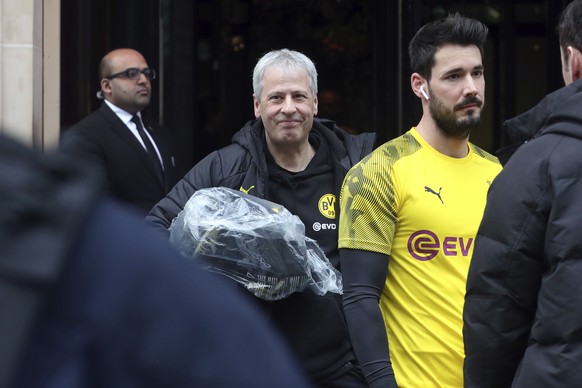 Borussia Dortmund&#039;s head coach Lucien Favre, center, and Roman Burki, right, leave their hotel for a training session the day before their Champions League match against Paris Saint-Germain, in P ...