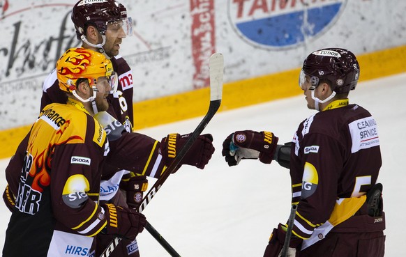 Geneve-Servette&#039;s center Eric Fehr #16, of Canada, celebrates his goal with teammates forward Linus Omark, of Sweden, left, and forward Guillaume Asselin, of Canada, right, after scoring the 4:0, ...